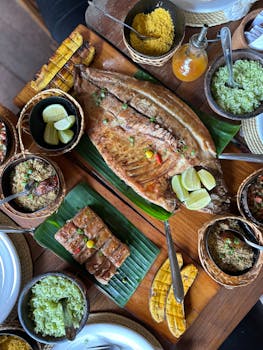 Aerial view of a traditional Brazilian meal with roasted fish and sides, rich in flavors.